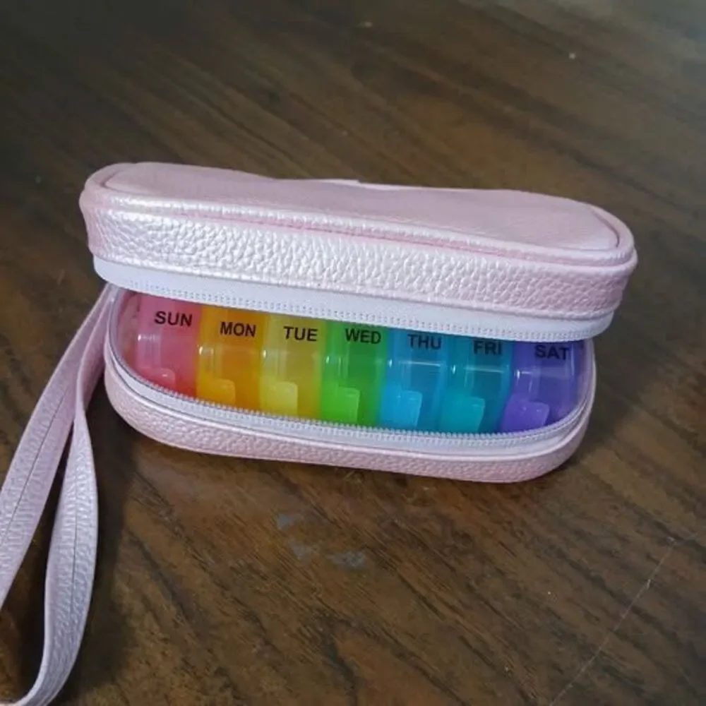 7-day pill organizer designed for use twice daily, w/ pink leather bag